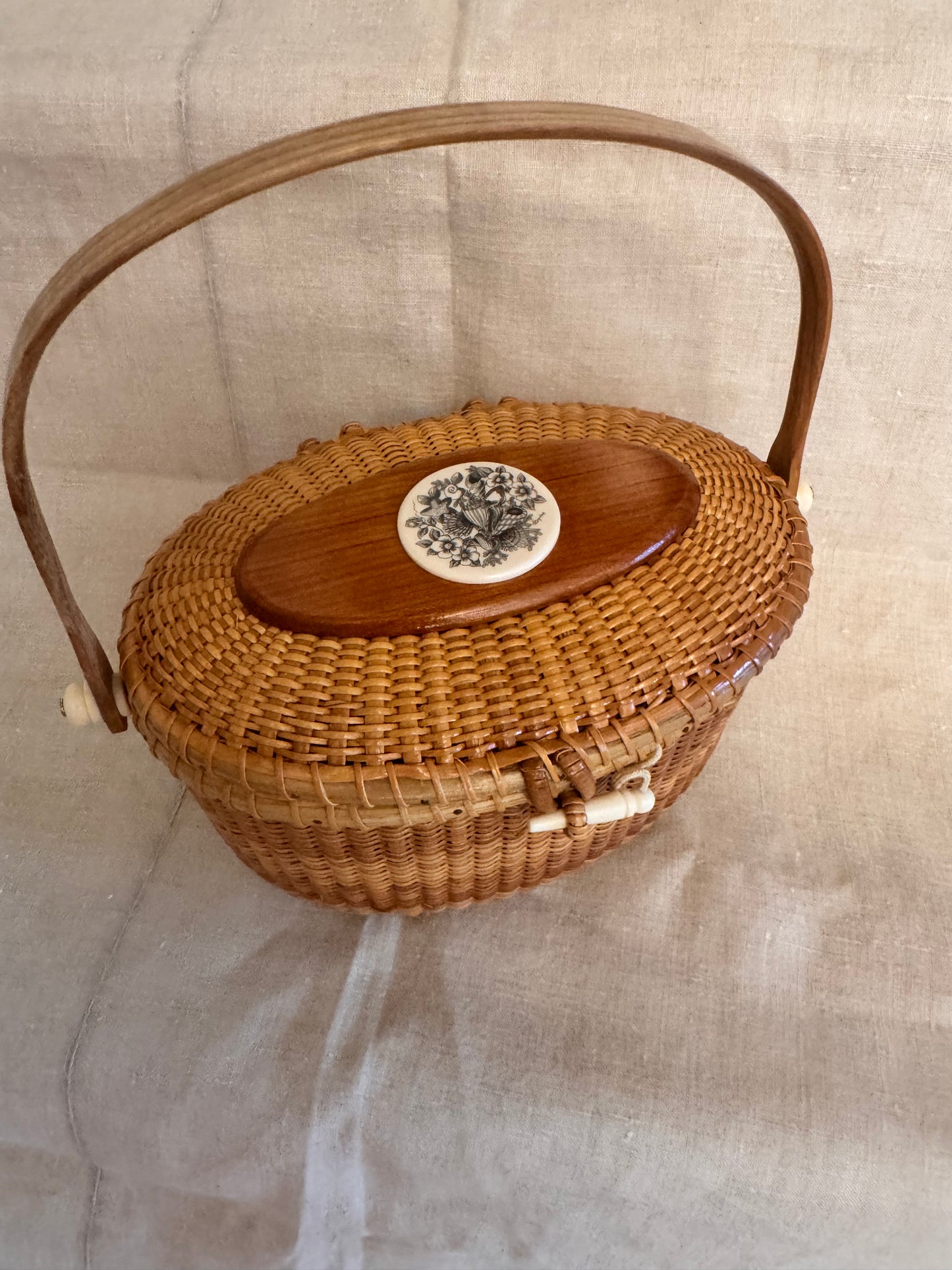 Large Oval Nantucket Basket with Reproduction Scrimshaw Shells and Rosa Rugosa