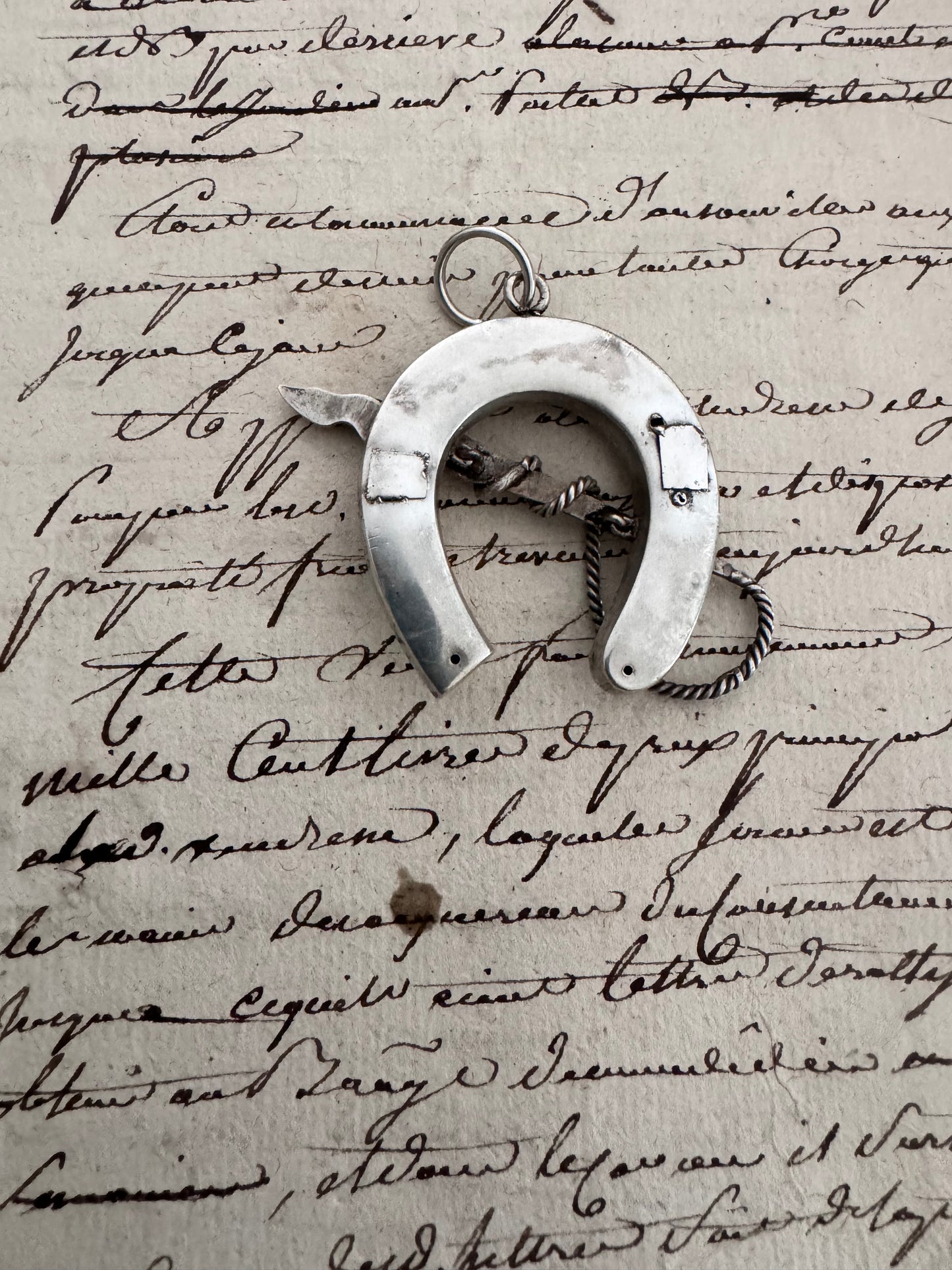 amazing horseshoe pendant with riding crop detail