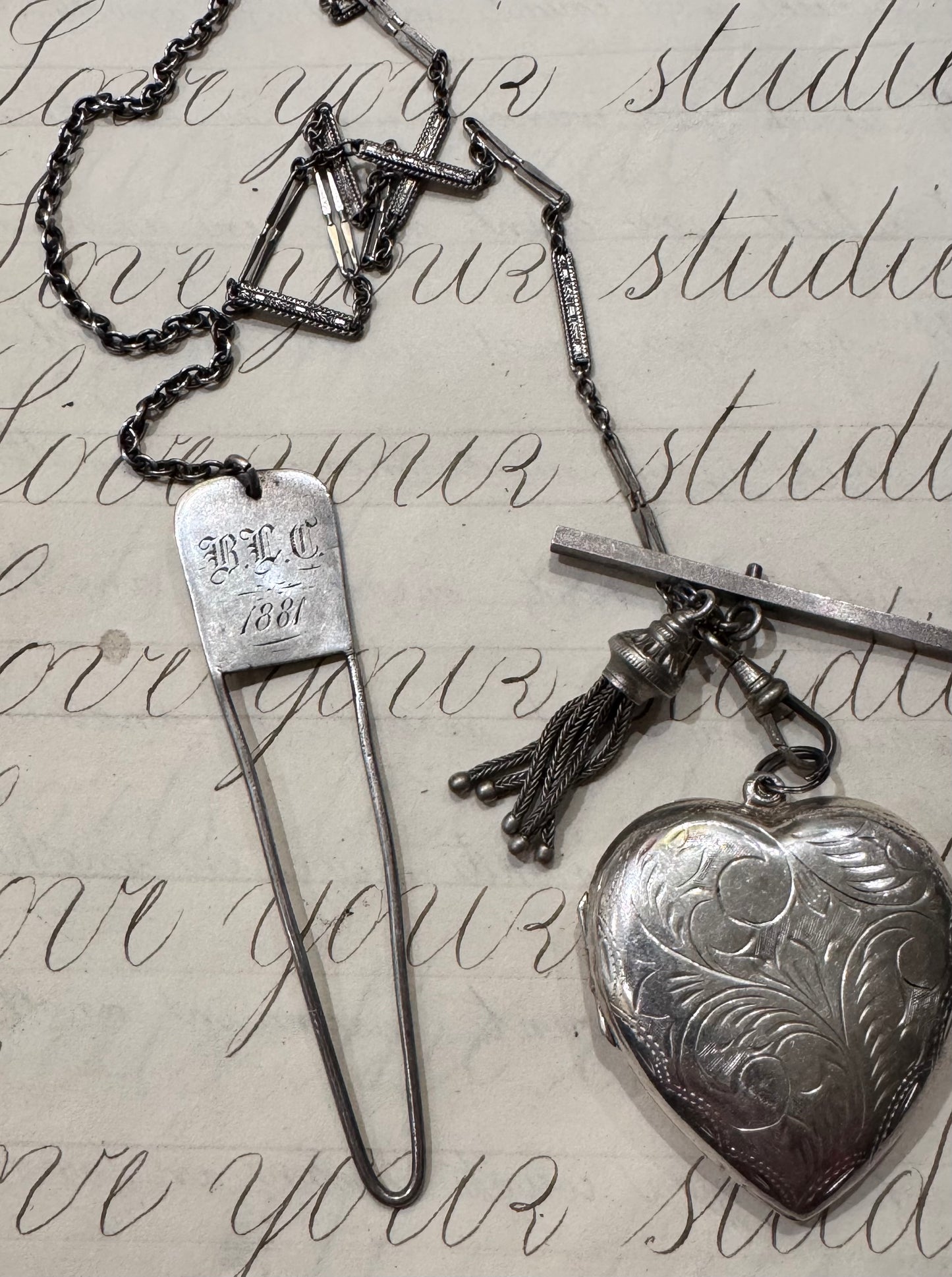 antique chain with large engraved heart locket and dated hanger with initials