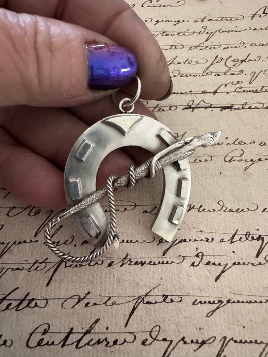 amazing horseshoe pendant with riding crop detail