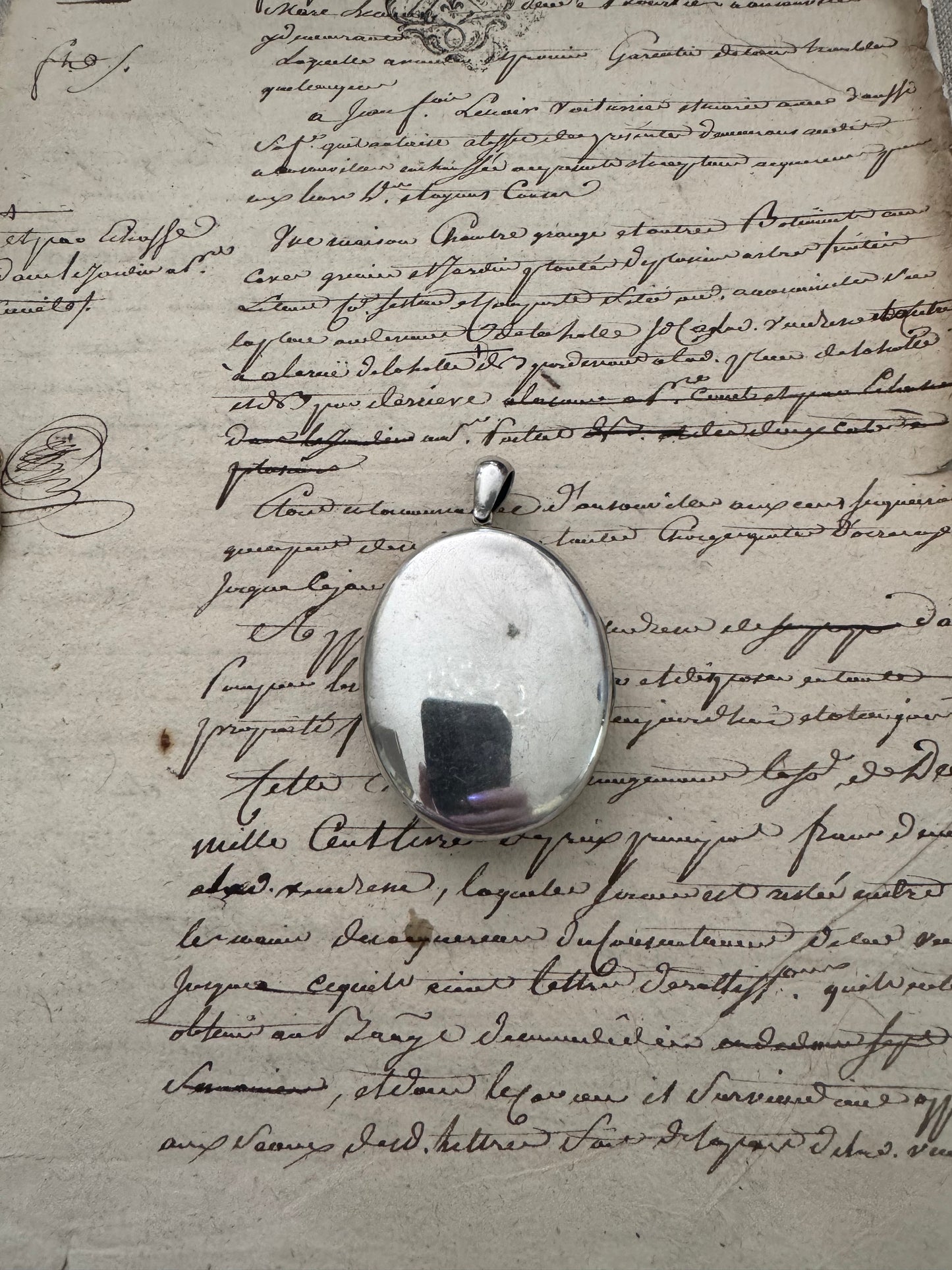 large European silver locket with appliquéd crest