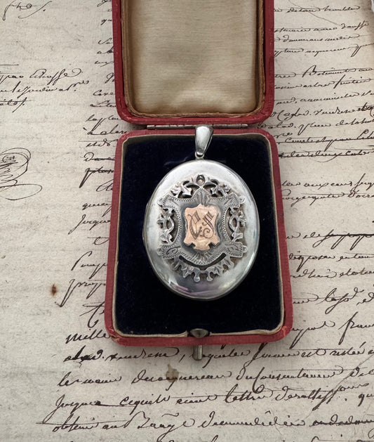 large European silver locket with appliquéd crest
