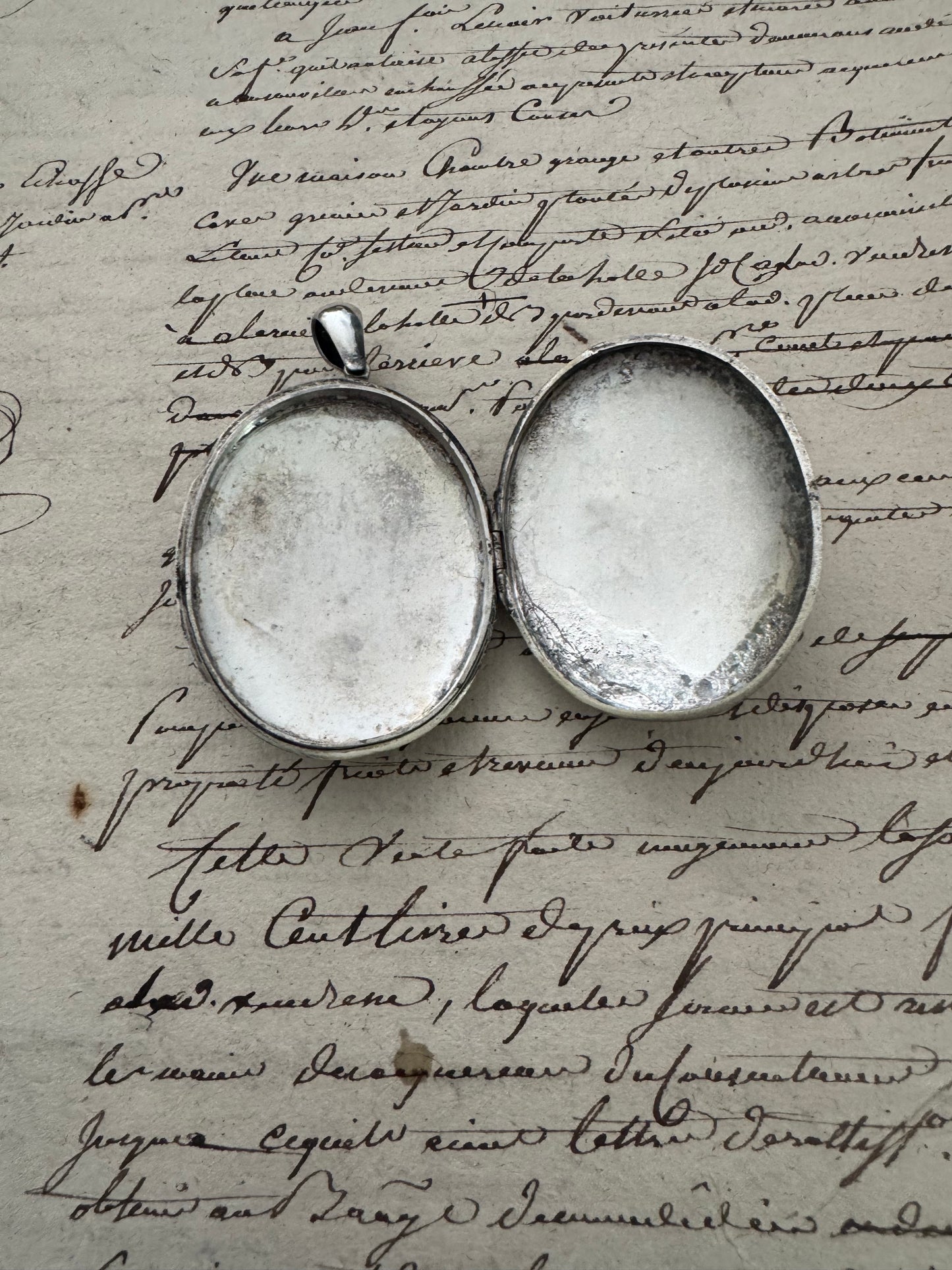 large European silver locket with appliquéd crest