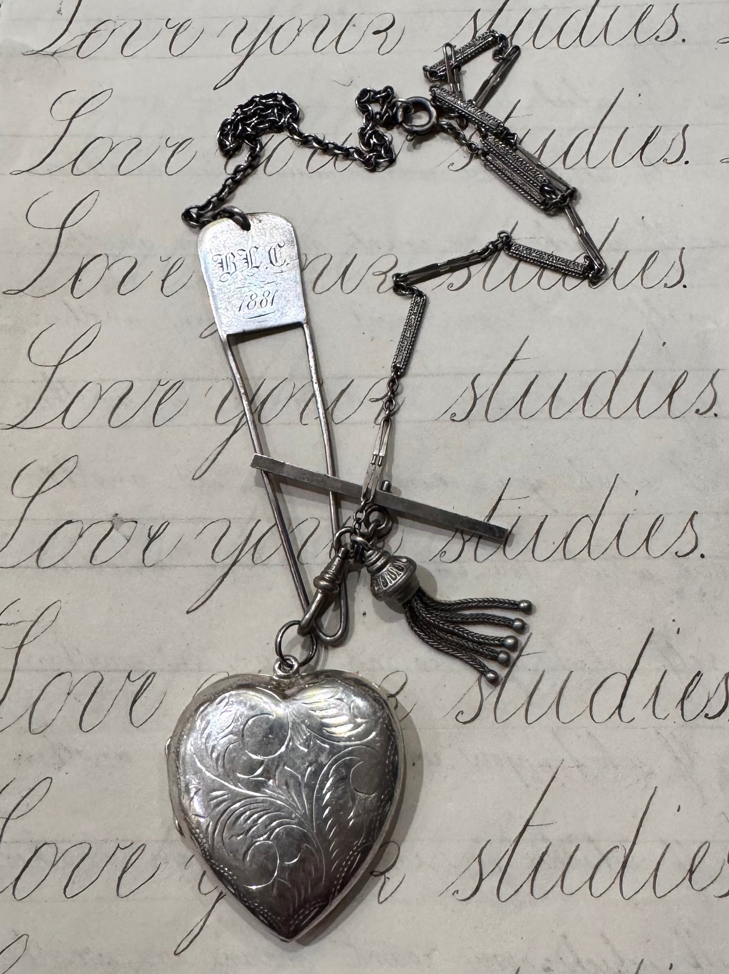 antique chain with large engraved heart locket and dated hanger with initials