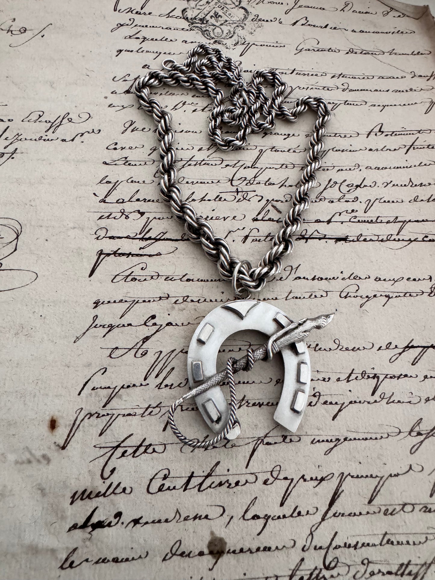 amazing horseshoe pendant with riding crop detail