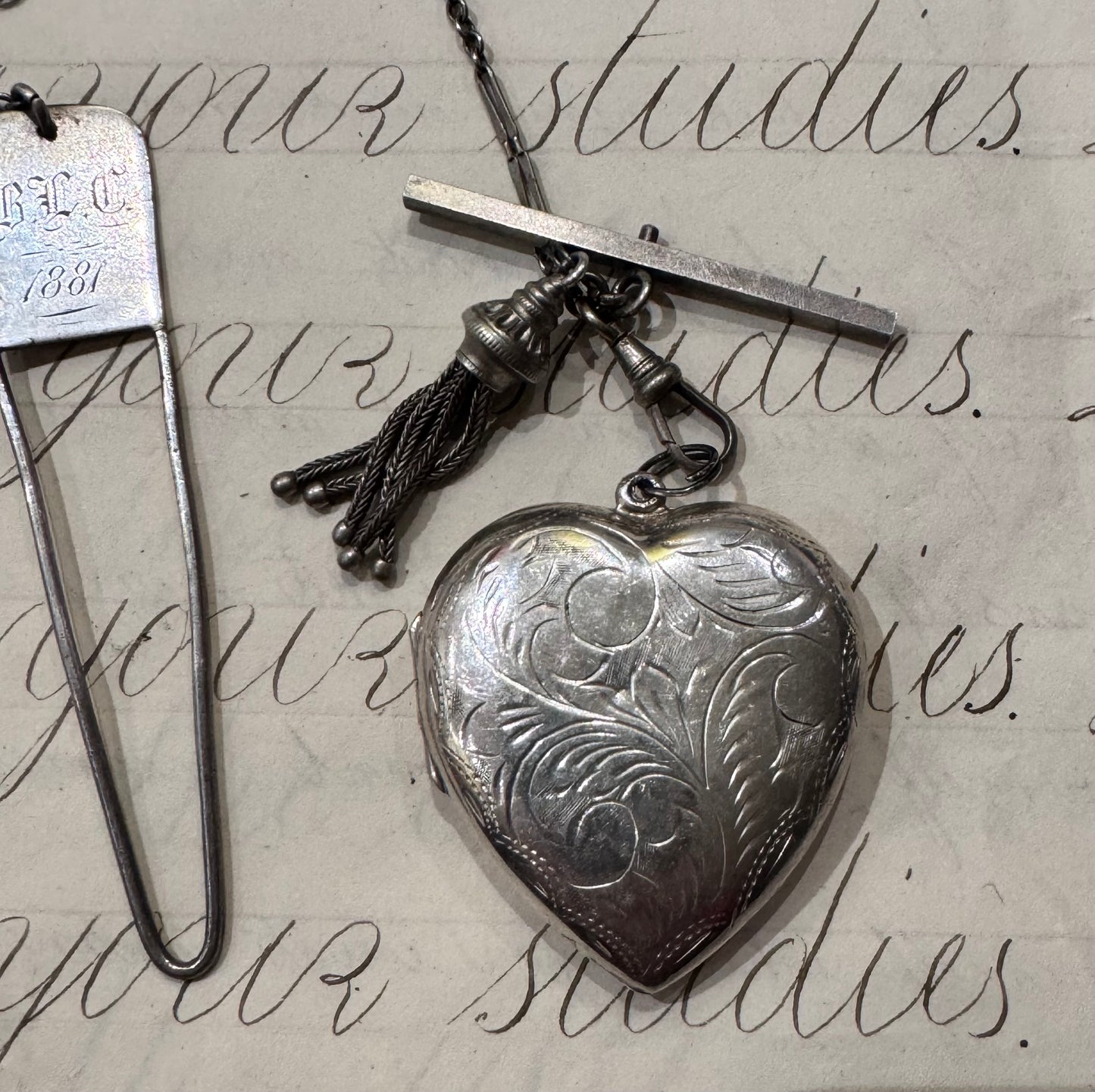 antique chain with large engraved heart locket and dated hanger with initials