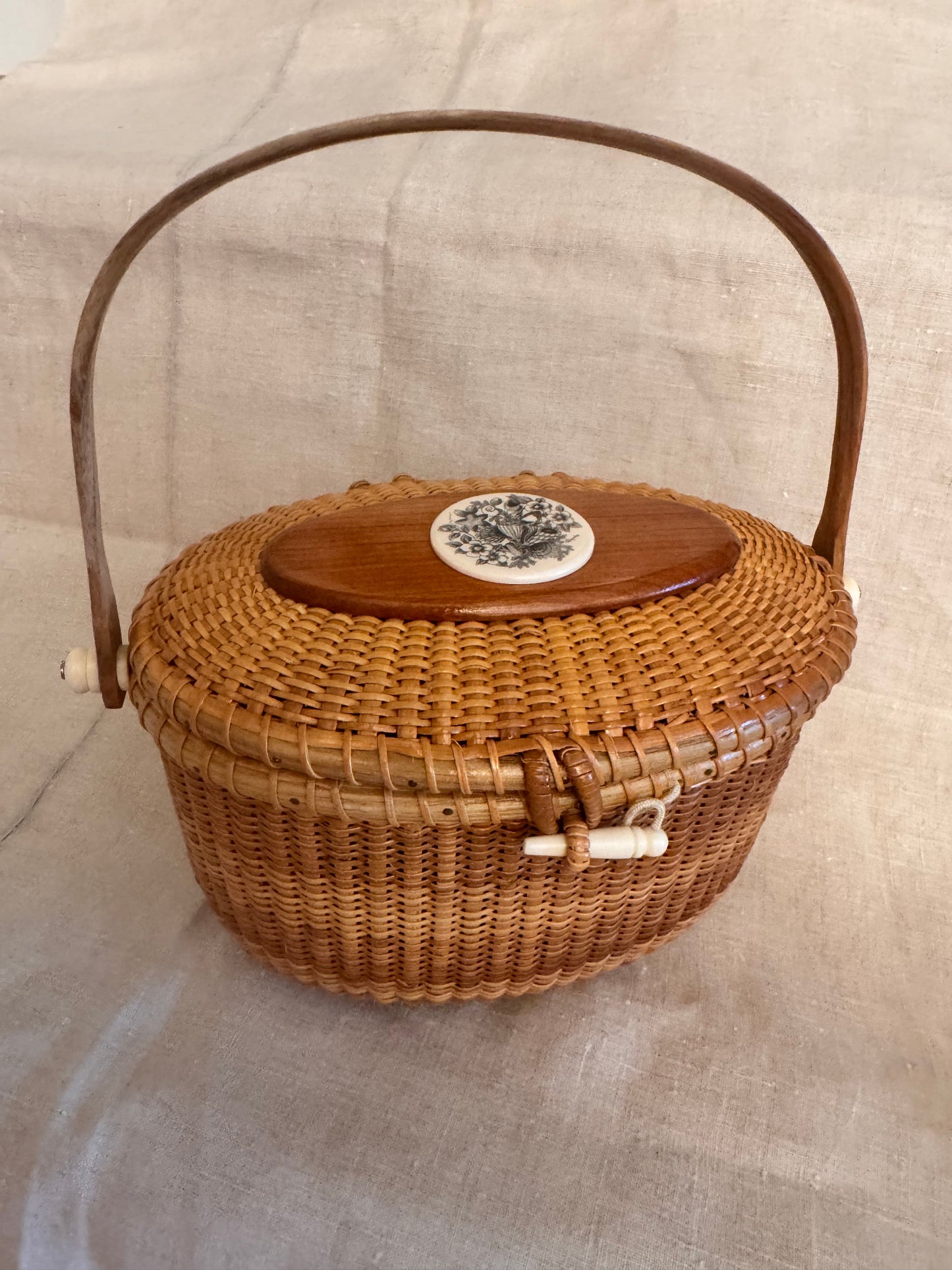Large Oval Nantucket Basket with Reproduction Scrimshaw Shells and Rosa Rugosa