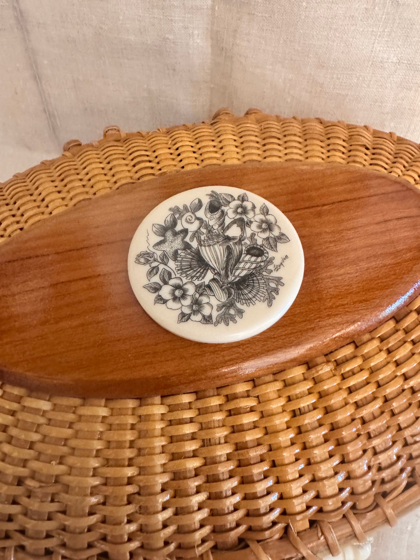 Large Oval Nantucket Basket with Reproduction Scrimshaw Shells and Rosa Rugosa