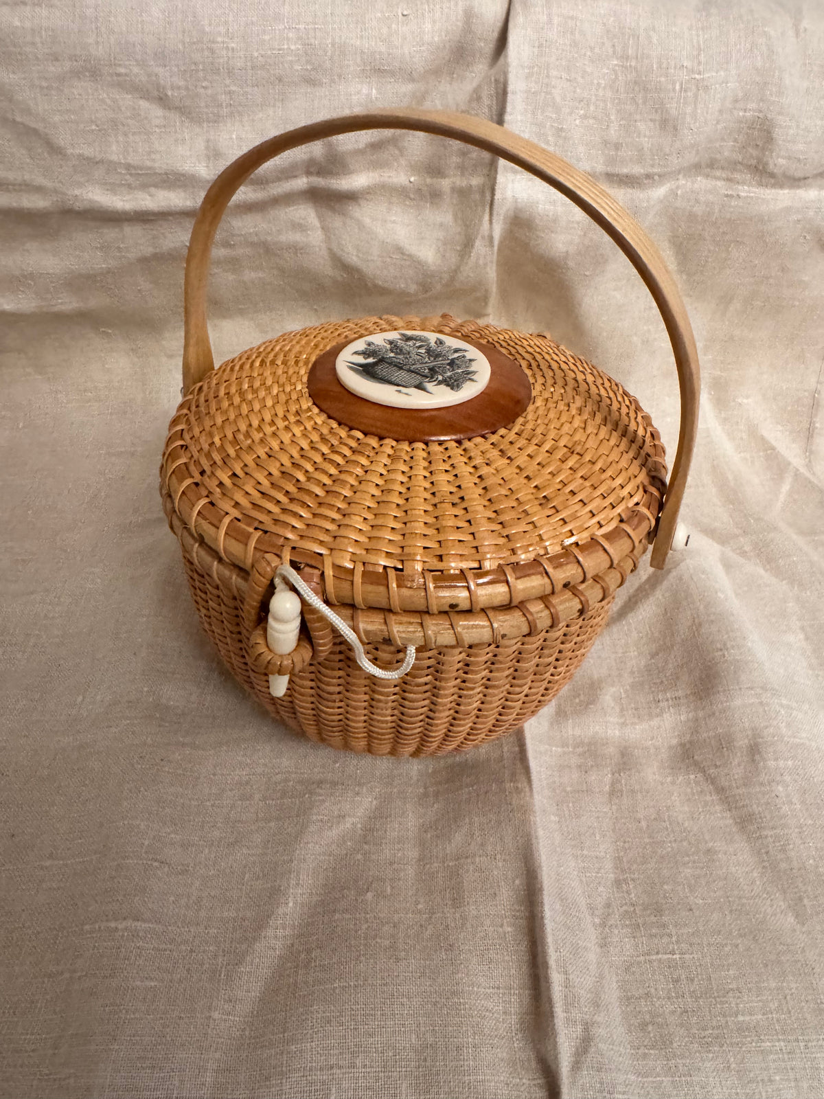 Medium Round Basket with Scrimshaw Nantucket Basket of Flowers