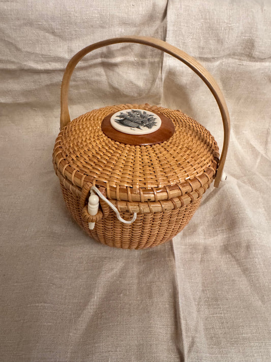 Medium Round Basket with Scrimshaw Nantucket Basket of Flowers